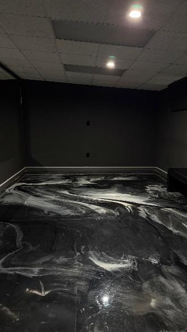 Empty room with a marbled black and white floor and dark walls