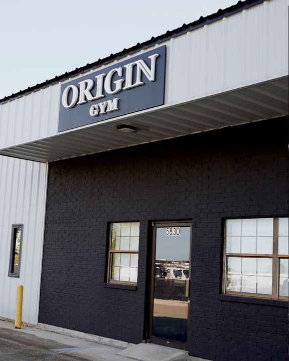 Origin Gym storefront and sign at 5830 McCann Drive