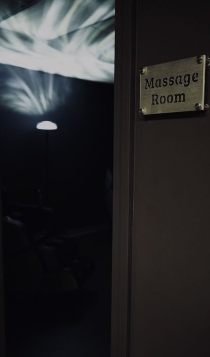 Massage Room door with brass plaque and soft light inside