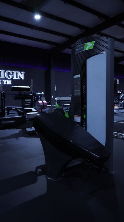 Prime machine with angled pad beneath the ORIGIN GYM sign