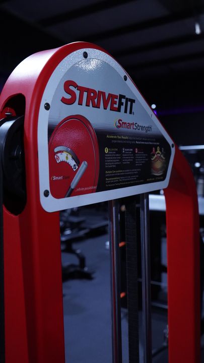 StriveFit SmartStrength brand plate on a red machine