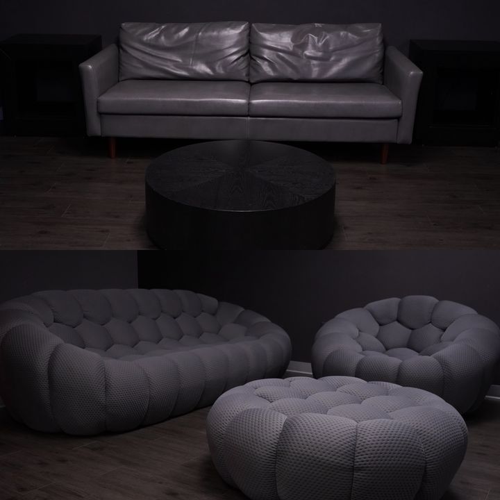 Lounge with leather sofa, round table and tufted ottomans